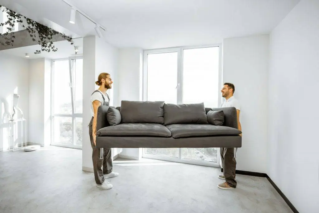 Movers placing couch at home for a professional Business Removals