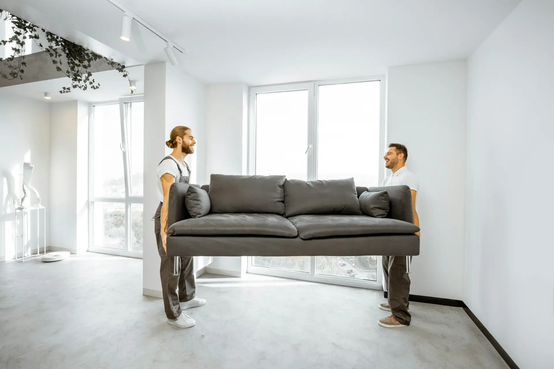 Movers placing couch at home for a professional Business Removals